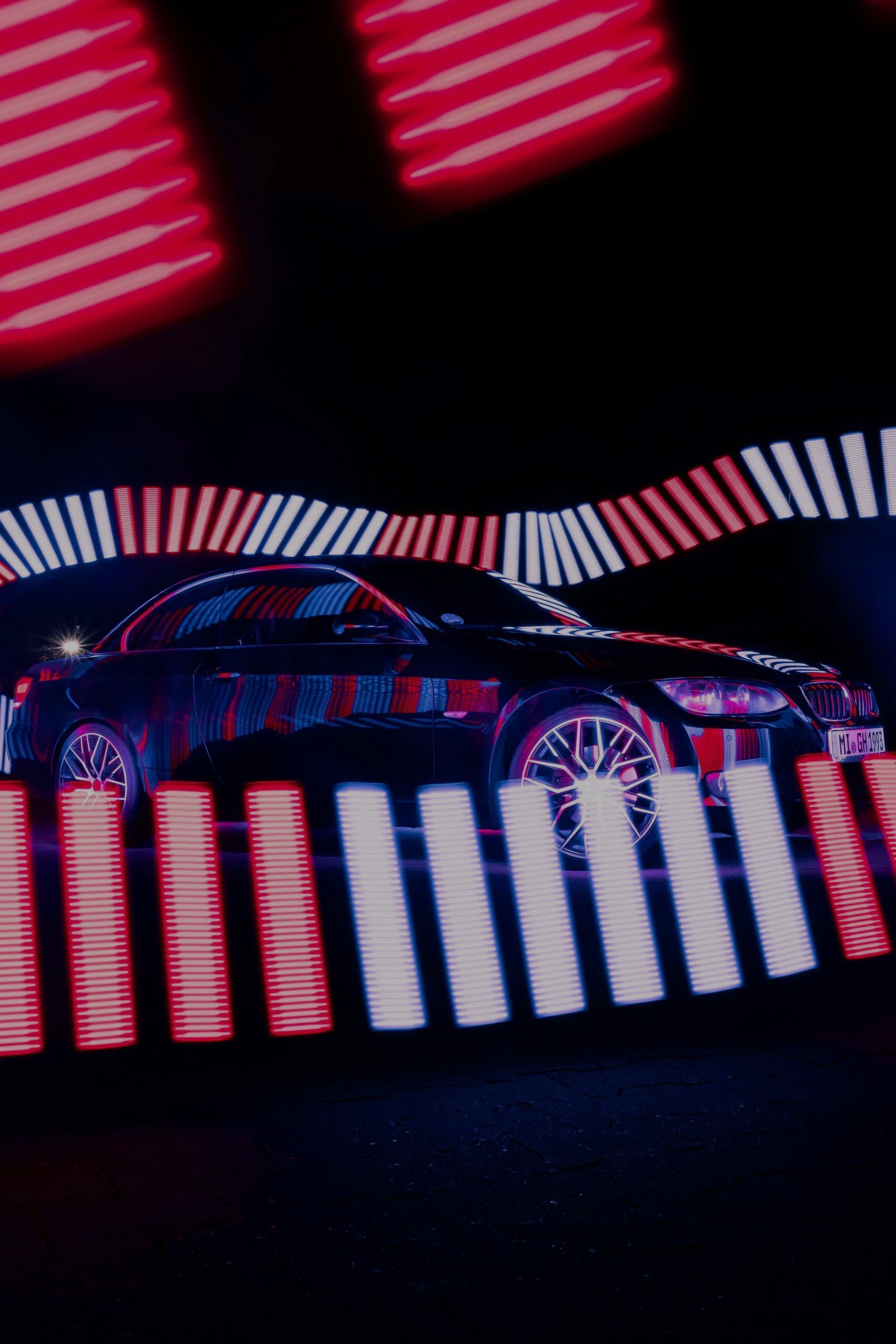 Car surrounded by neon lights
