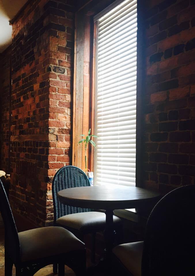 Small dining nook with large window beside it