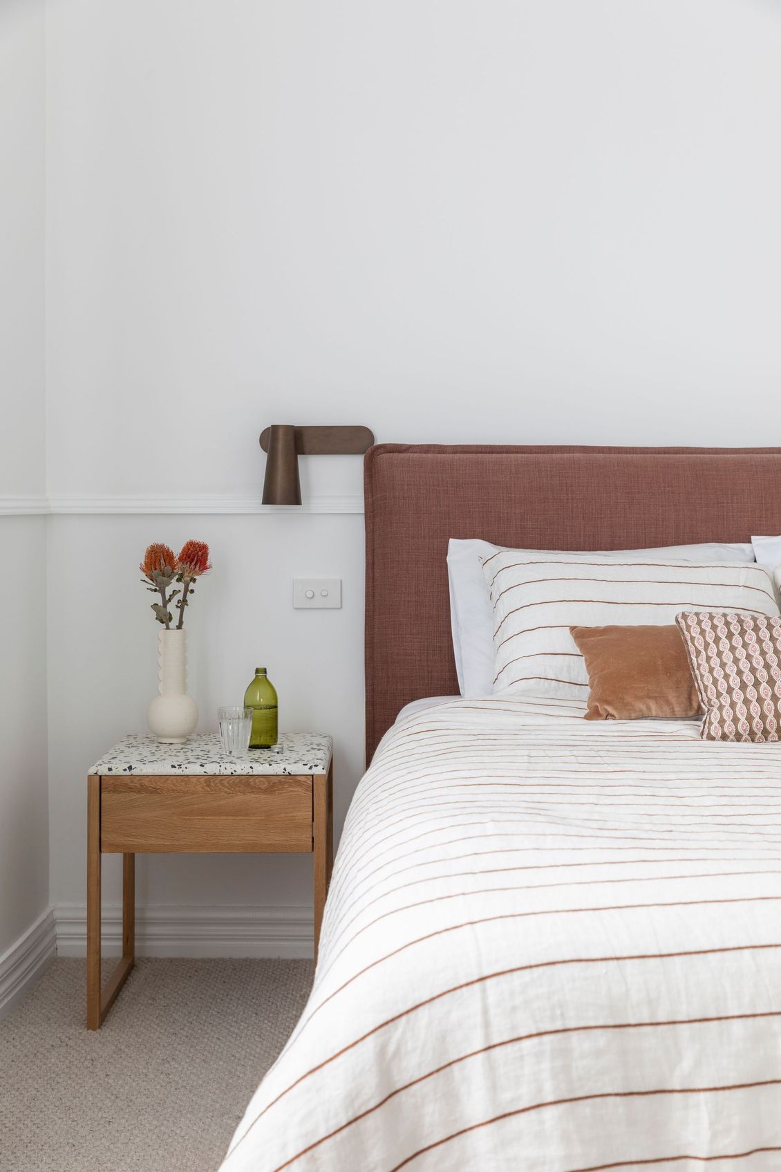 Stylish wooden side table next to the bed (side view of the bed)— Caroline Jolly Interiors in Bulli, NSW