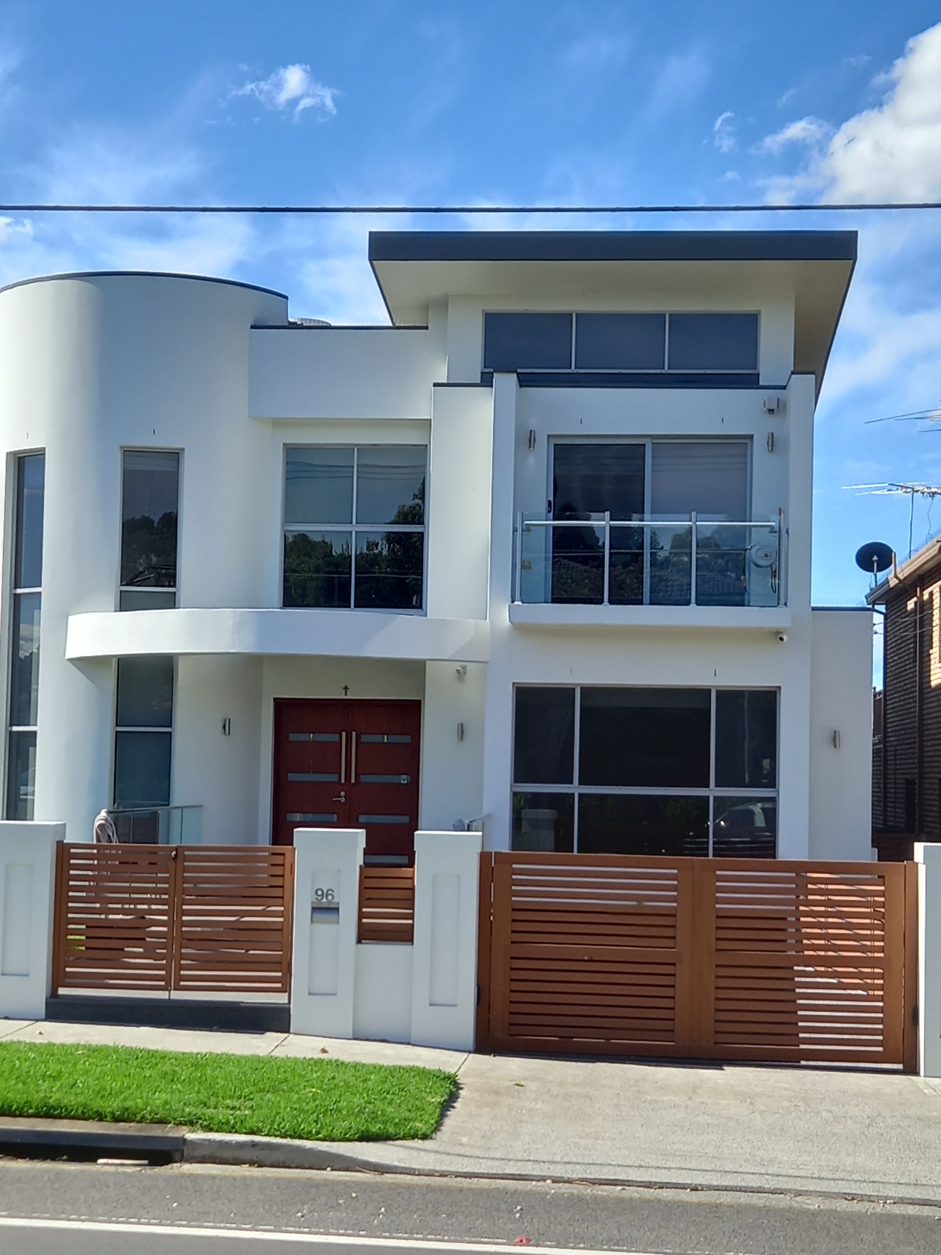 A white house with a wooden fence in front of it