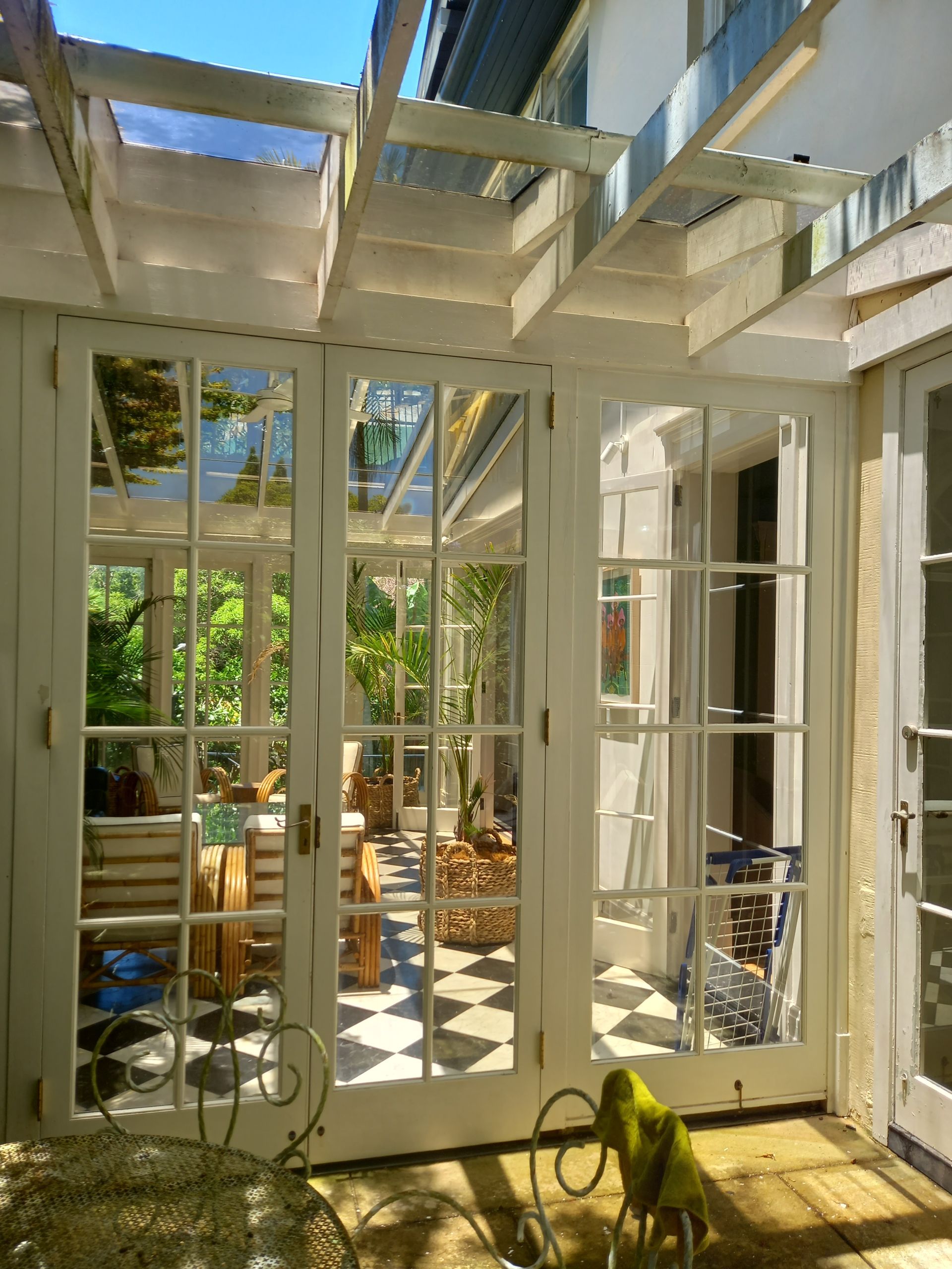 A room with french doors leading to a patio