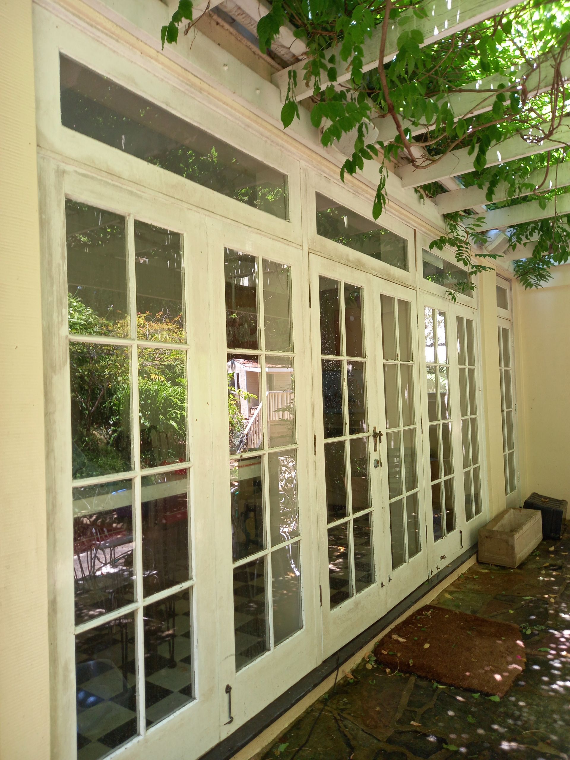 A row of white french doors leading to a patio