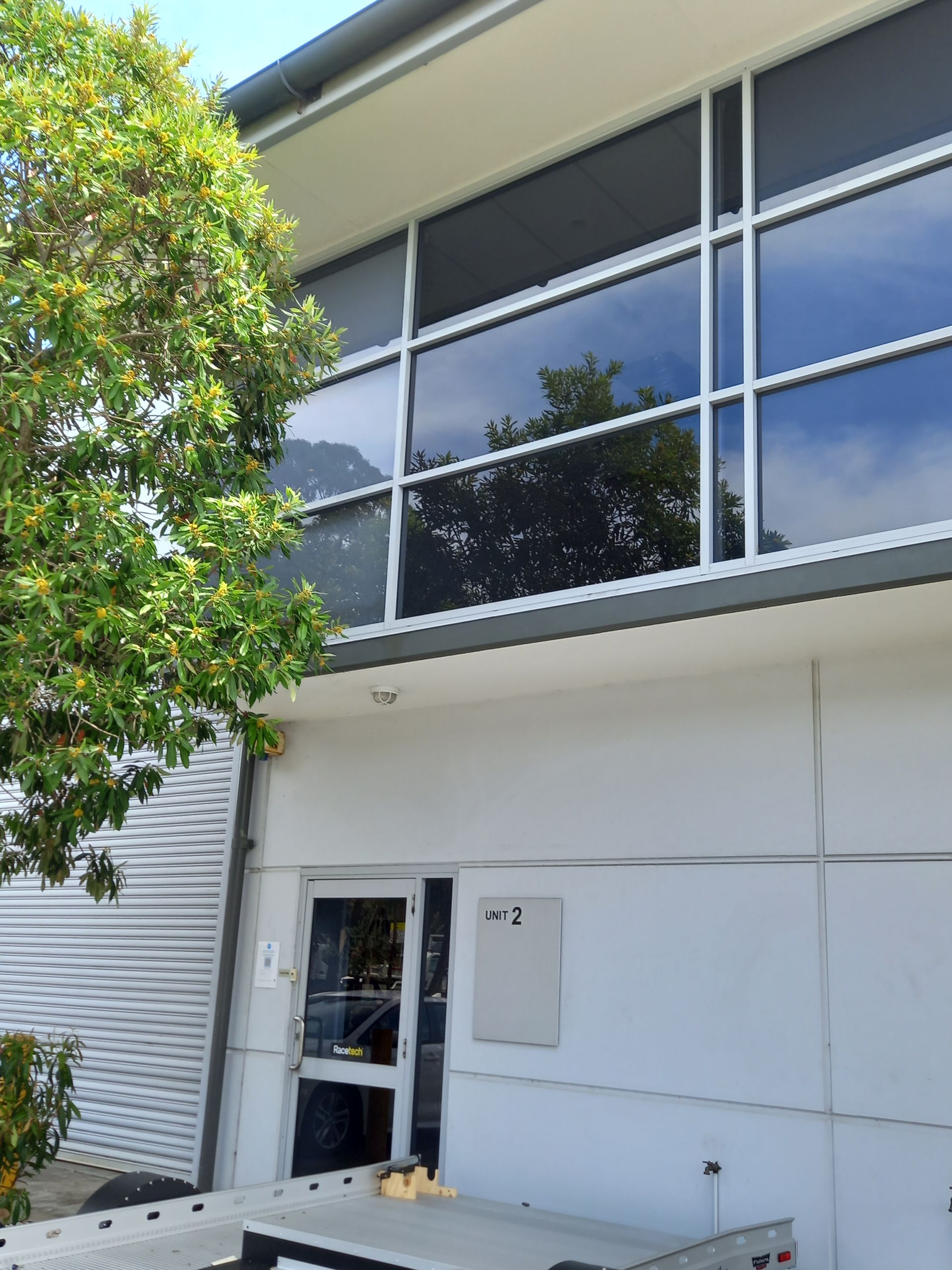 A building with a lot of windows and a tree in front of it