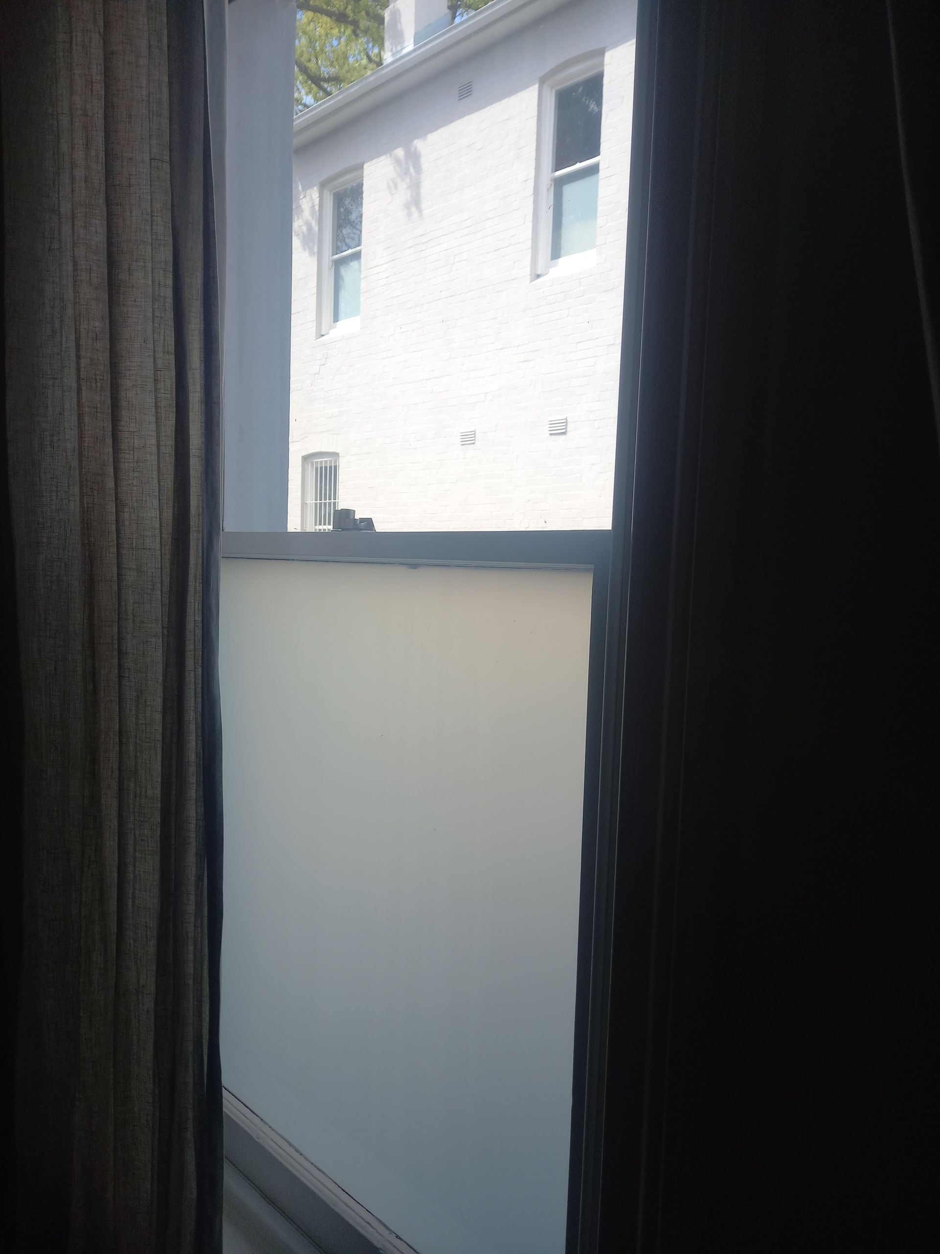 A balcony with a white building in the background