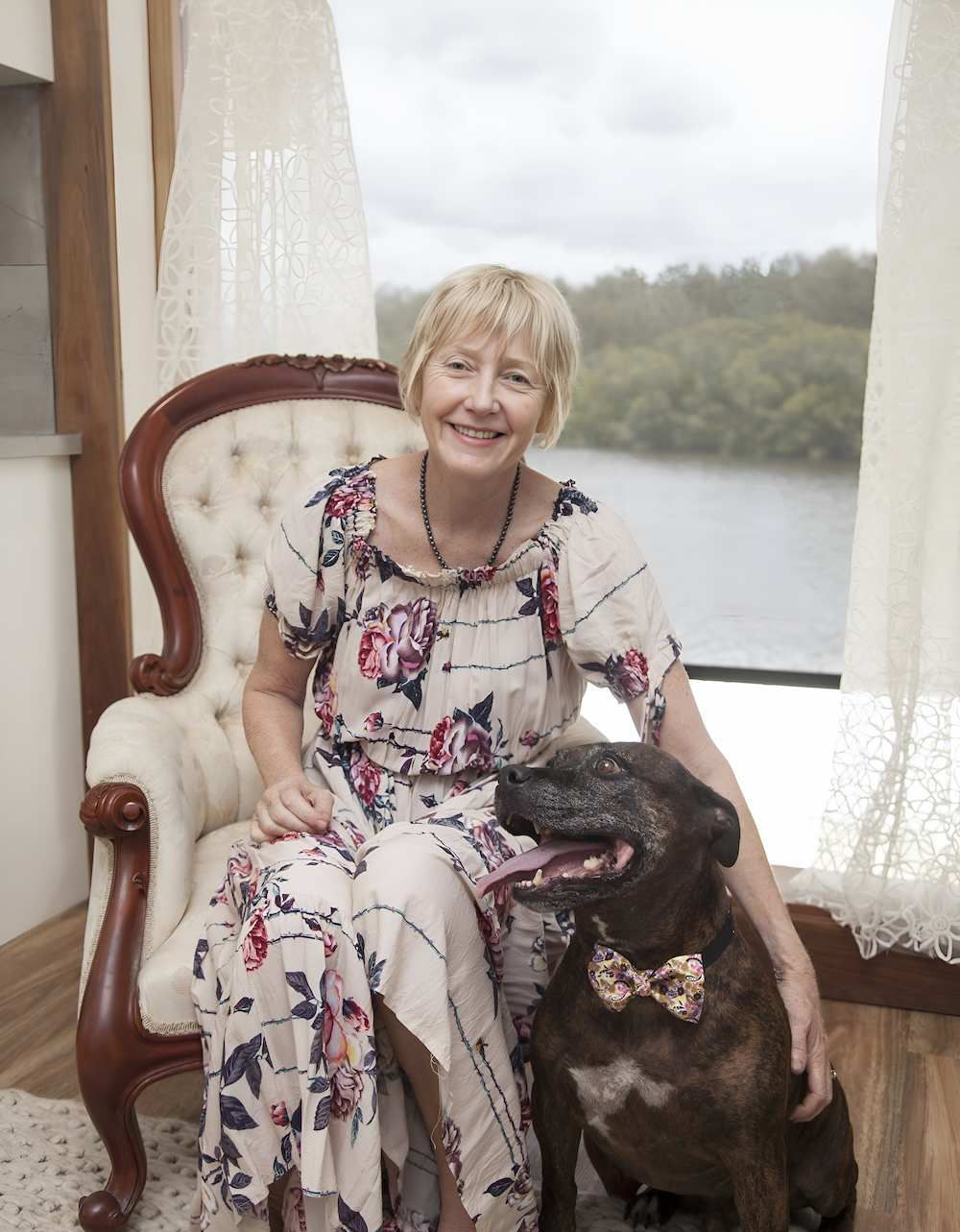 A Woman Is Sitting In A Chair Next To A Dog Wearing A Bow Tie — Psychology Practice In Tweed Heads, NSW