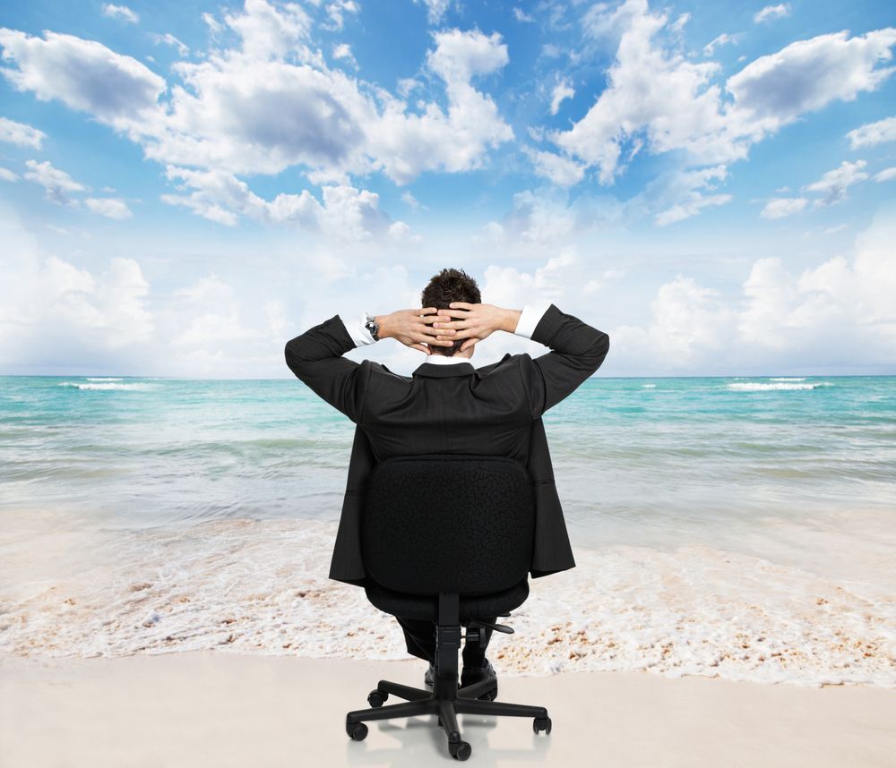A Man in a Suit is Sitting in an Office Chair on the Beach — Psychology Practice In Tweed Heads, NSW