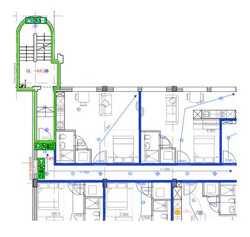 A person in glasses, focused on dual monitors displaying complex code and data in blue tones
