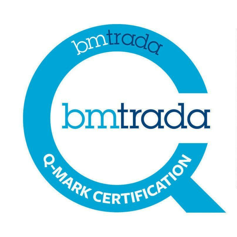 A security guard in uniform talks on a phone, surrounded by multiple surveillance screens