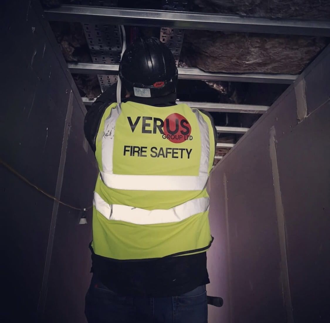 Empty, bright white office space with large windows and exposed ceiling fixtures.
