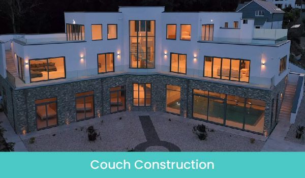 Modern white multi-story house with stone facade, large windows, and pool.