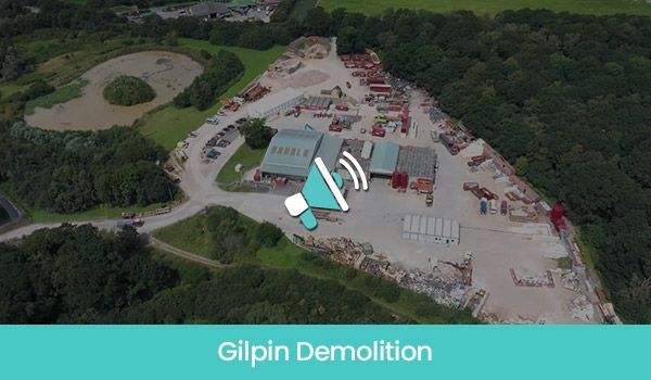Aerial view of Gilpin Demolition site with structures, debris, equipment, and surrounding trees.