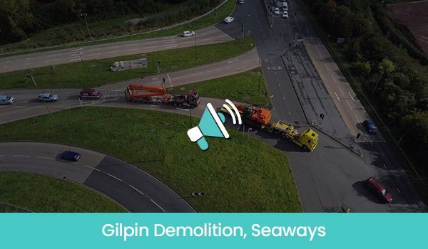 Aerial view of Gilpin Demolition at Seaways, with heavy machinery on a road, surrounded by grass and cars.