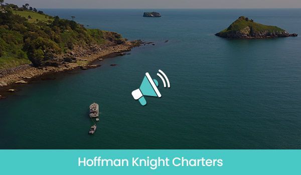 Aerial view of boats on turquoise water, islands, and a green coastline. Hoffman Knight Charters logo present.