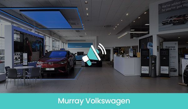 Interior of Murray Volkswagen car dealership with a red car on display.