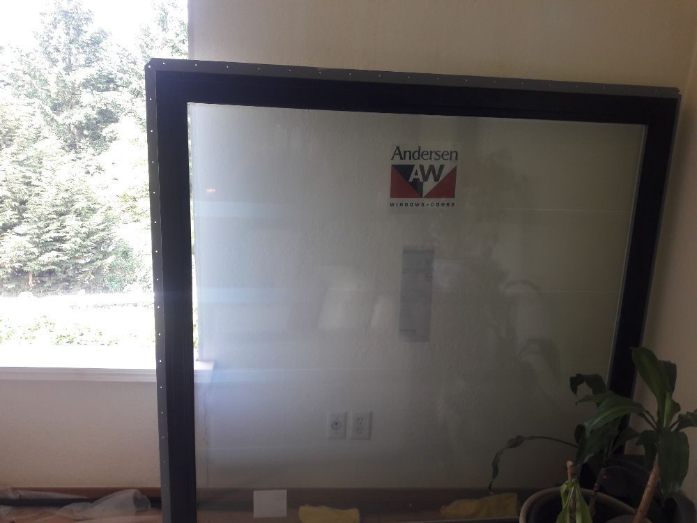 A window with a sticker on it that says anderson w