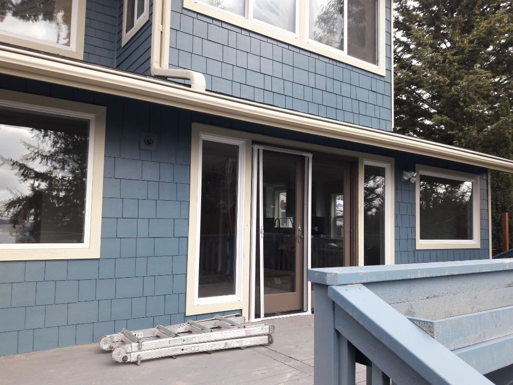 A blue house with a sliding glass door