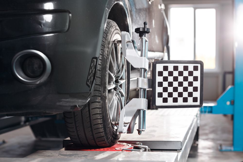 Car on Stand With Sensors Wheels For Alignment — Panel Beaters in Mitchell, ACT