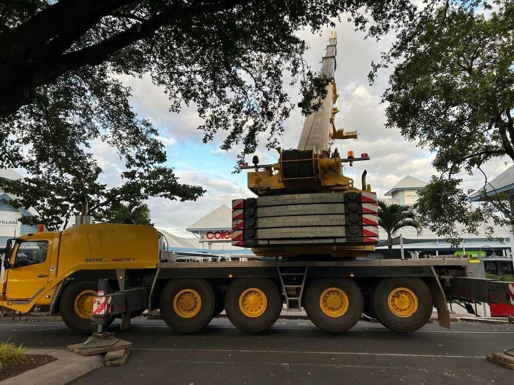 A Large Yellow Crane is Parked on the Side of the Road — Kelly's Crane Hire in Mossman, QLD