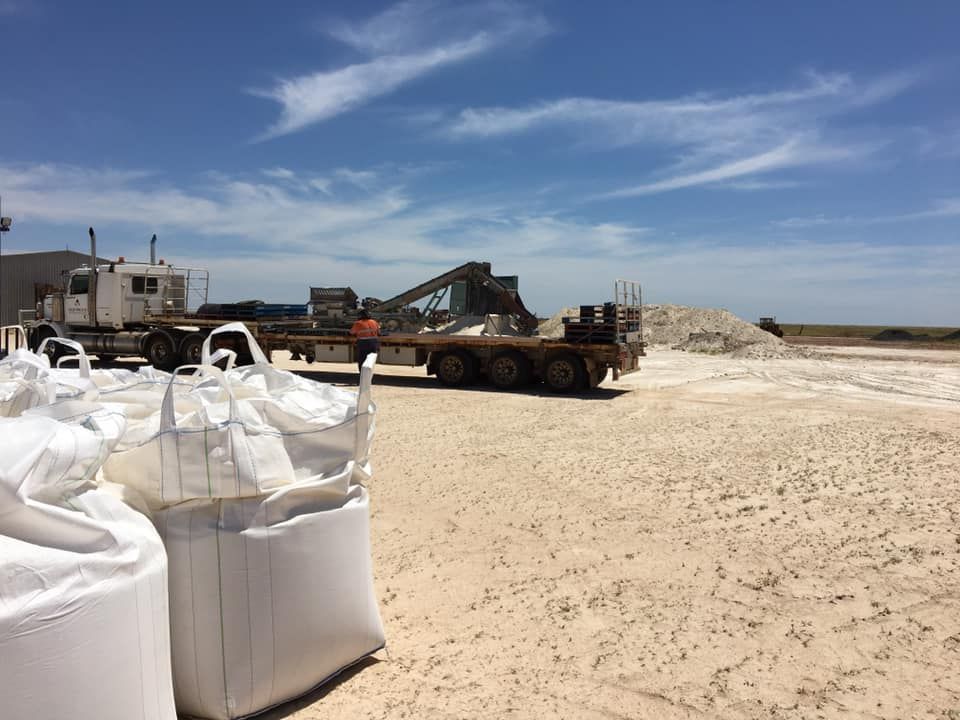 A Large White Bag is Sitting on the Ground Next to a Truck — Kelly's Crane Hire in Mossman, QLD