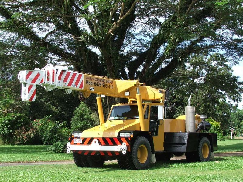 A Yellow Truck With a Crane on Top of It — Kelly's Crane Hire in Mossman, QLD