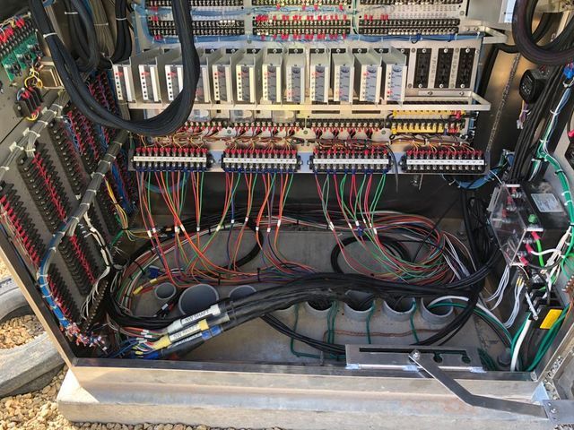 Open electrical control panel with various colored wires and components.