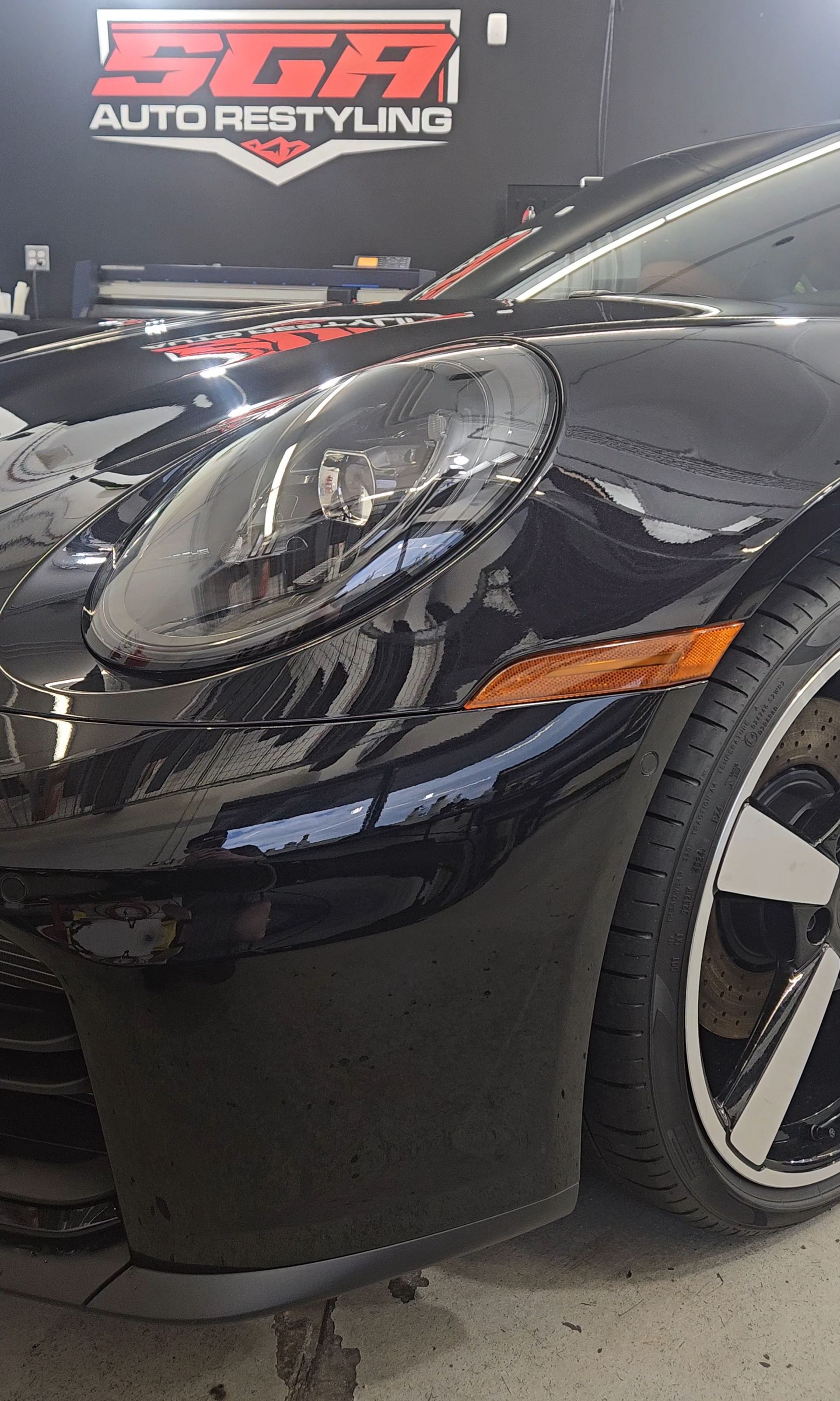 Black Porsche sports car in a garage with 