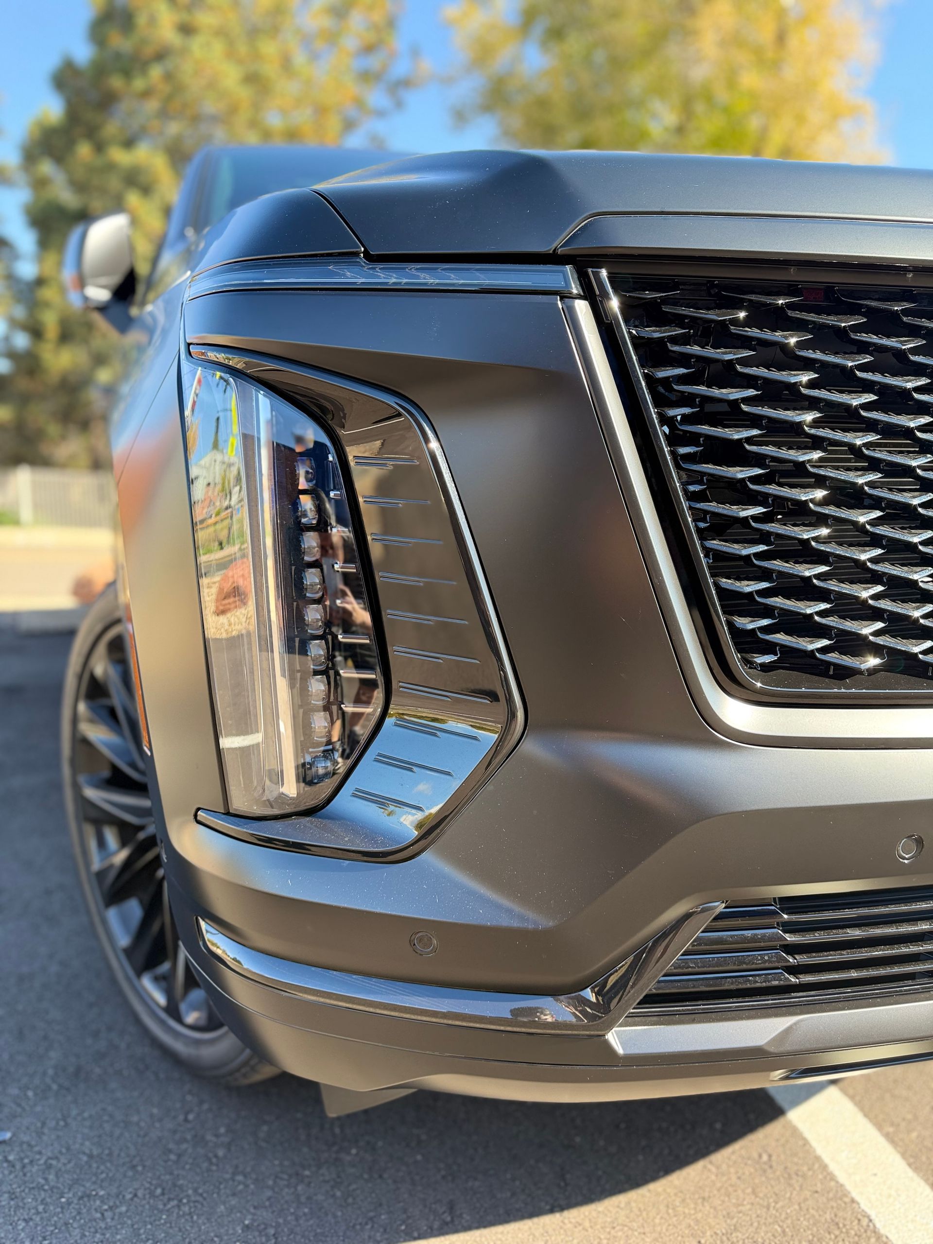 Black matte SUV front view, with a black grille and headlights.