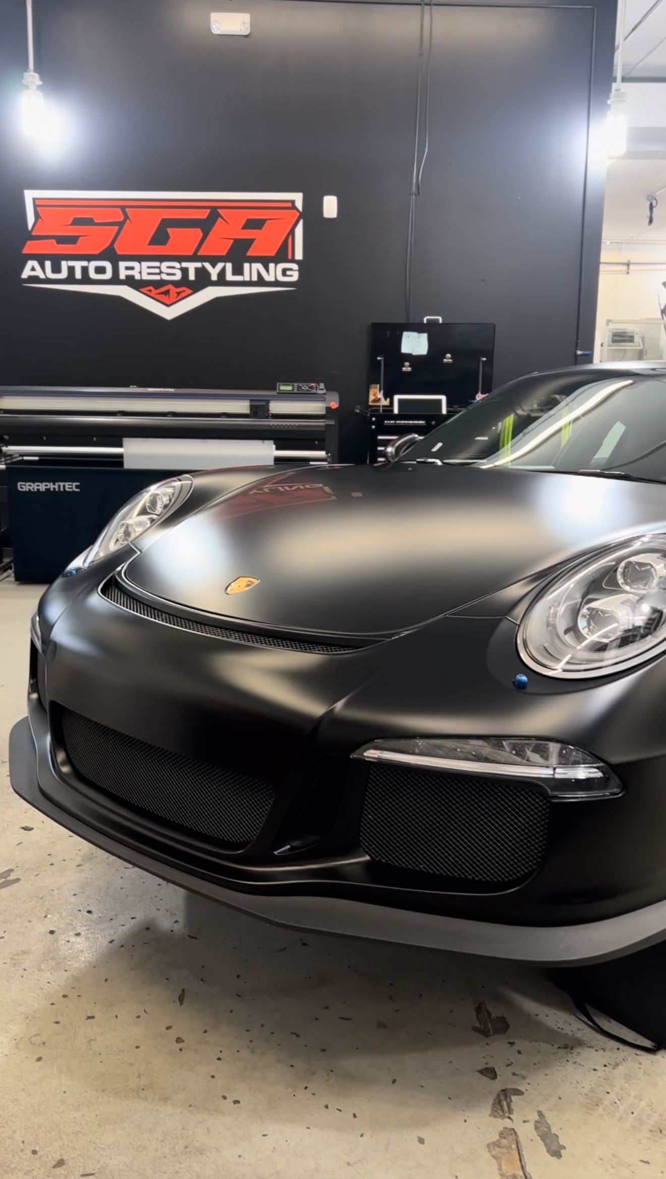 Black Porsche sports car in a shop with 