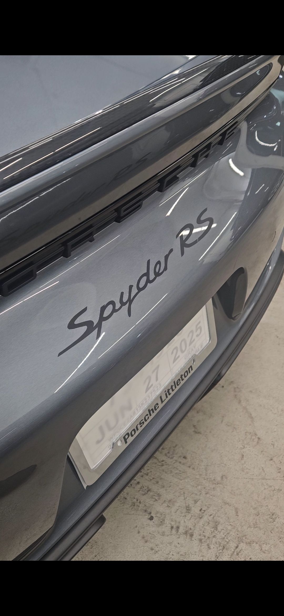 Gray Porsche Spyder RS rear with badging, license plate and spoiler.