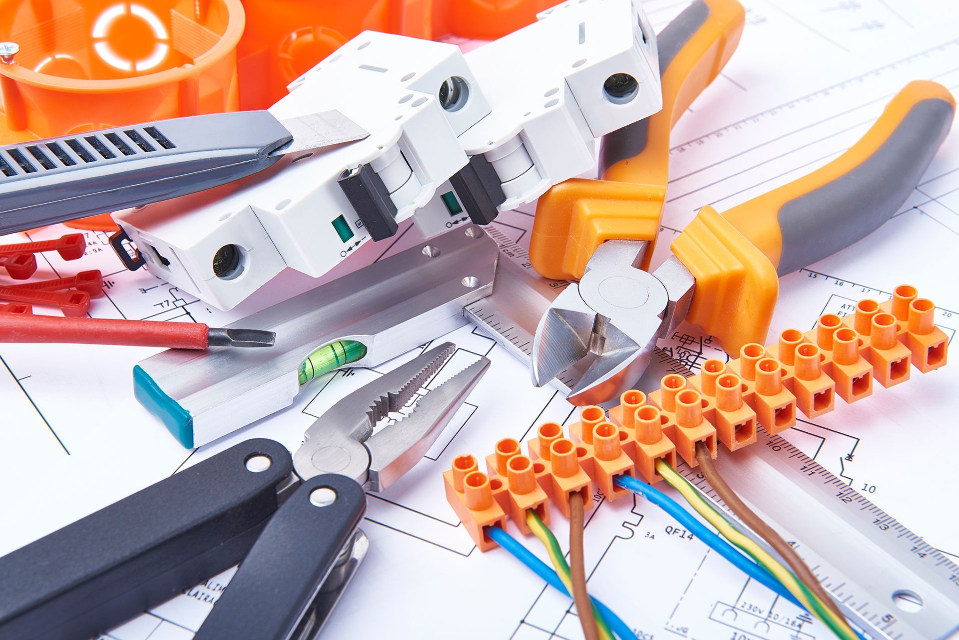 A bunch of electrical tools laying on top of a drawing