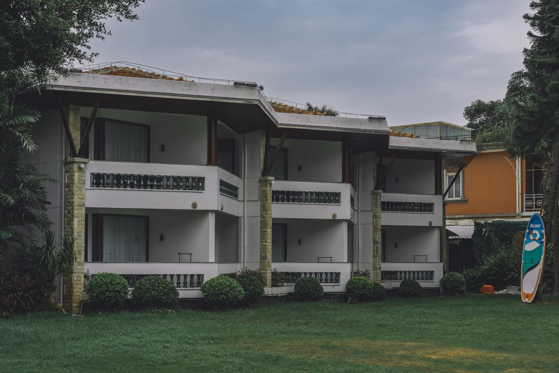 A row of buildings with trees in front of them at night.