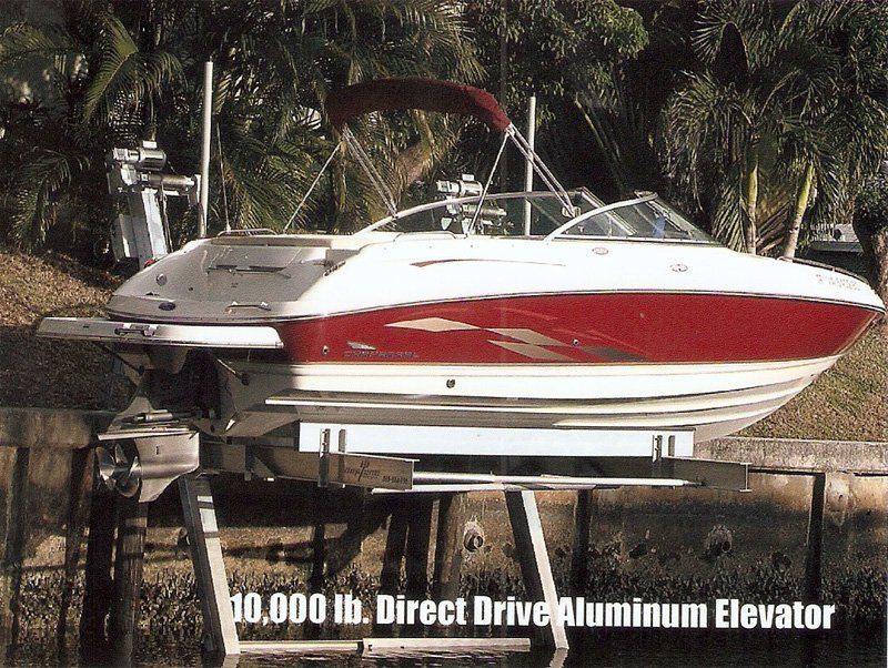 Boat Lifts — White and Red Boat in Lift in Miami, FL