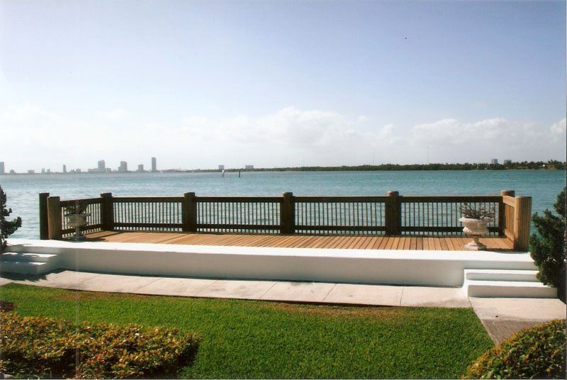 Wooden Deck Install — Grass And Flower Near Deck in Miami, FL