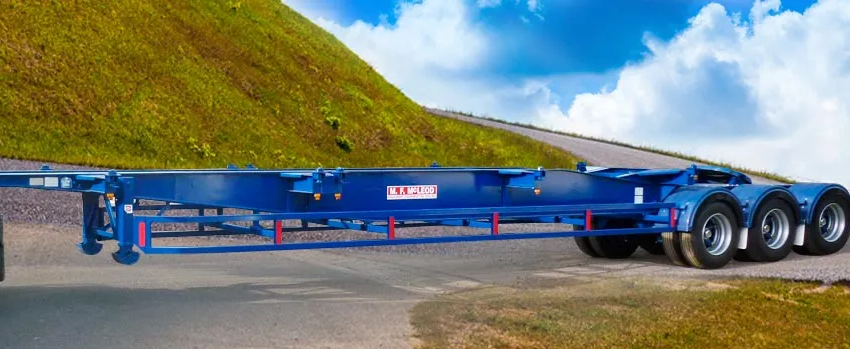 A blue trailer is parked on the side of a road.