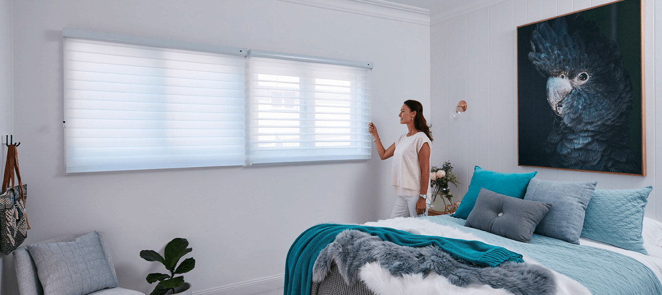 Woman Touches Her New Window Blinds — Simply Smarter Blinds in Tea Gardens, NSW
