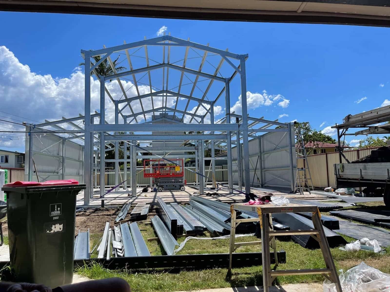 A Large Metal Structure Is Being Built In A Yard — Just Sheds In Kunda Park, QLD