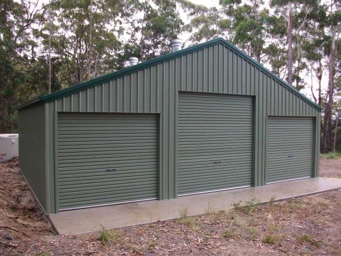 A Green Garage With Three Roller Doors And A Green Roof — Just Sheds In Sunshine Coast, QLD