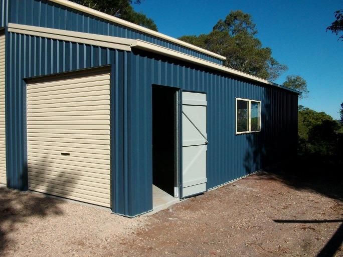 A Blue Garage With A White Door And A Window — Just Sheds In Ipswich, QLD