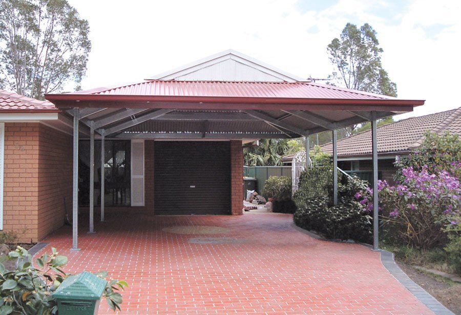 A Brick House With a Carport in Front of It — Just Sheds In Kunda Park, QLD
