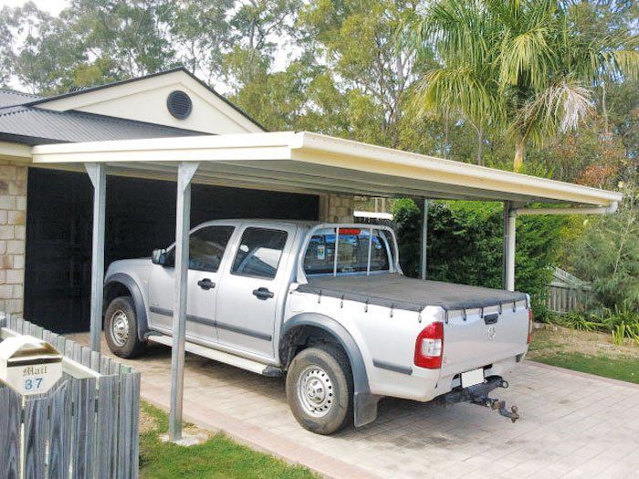 A Silver Truck is Parked Under a Carport in Front of a House — Just Sheds In Kunda Park, QLD