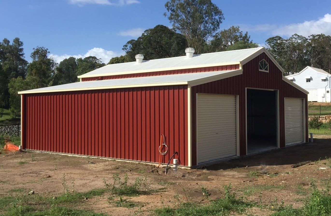 A Red Barn With A White Roof Is Sitting In The Middle Of A Field — Just Sheds In Brendale, QLD