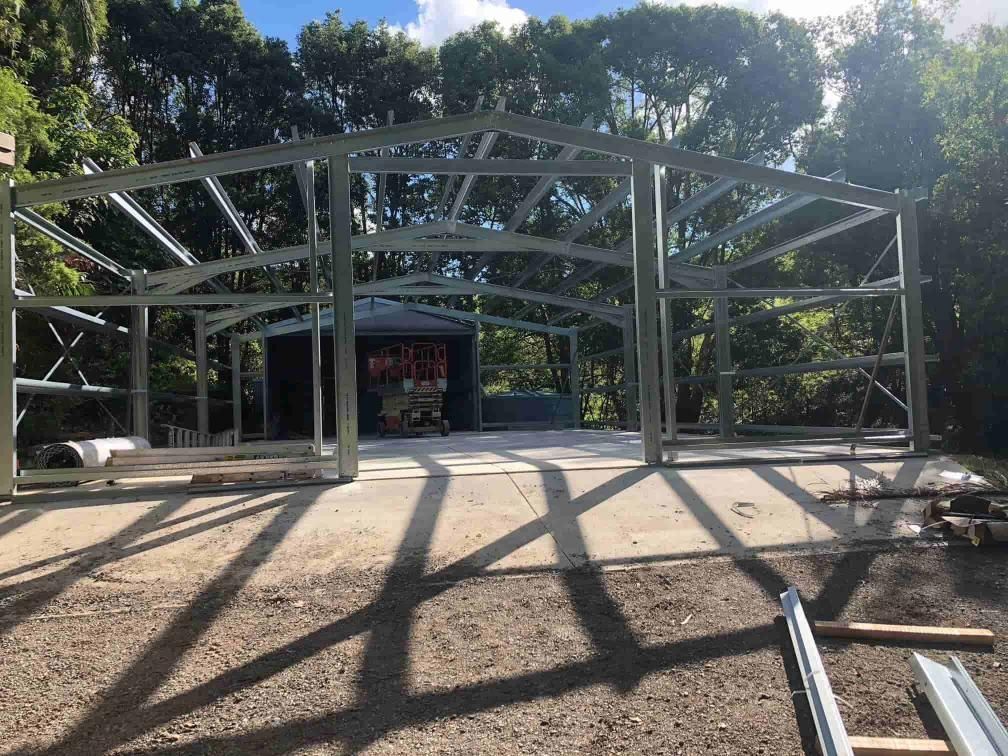 A Large Metal Structure Is Being Built In The Middle Of A Dirt Field— Just Sheds In Kunda Park, QLD