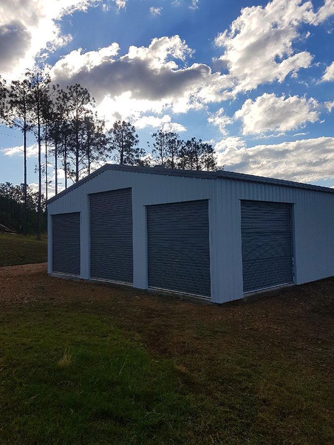 A White Garage With Three Garage Doors — Just Sheds In Kunda Park, QLD