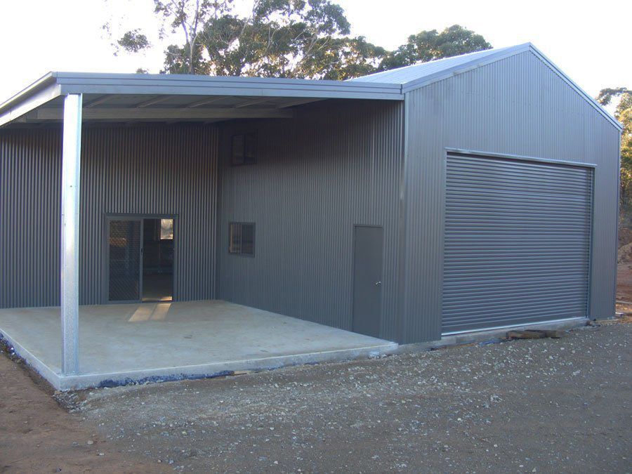 A Car is Parked Under a Carport in Front of a Garage — Just Sheds In Kunda Park, QLD