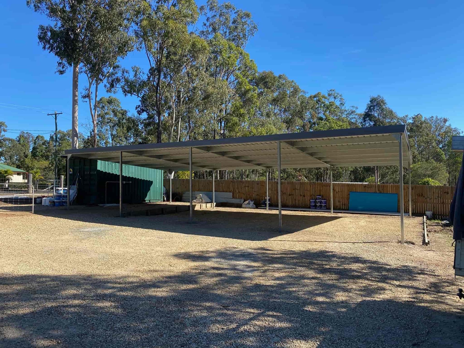 There is a carport in the middle of a dirt field. — Just Sheds In Brisbane, QLD