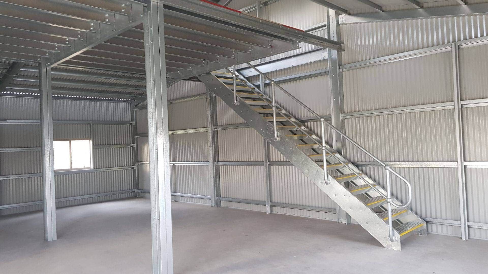 A metal building with stairs leading up to the second floor. — Just Sheds In Kunda Park, QLD