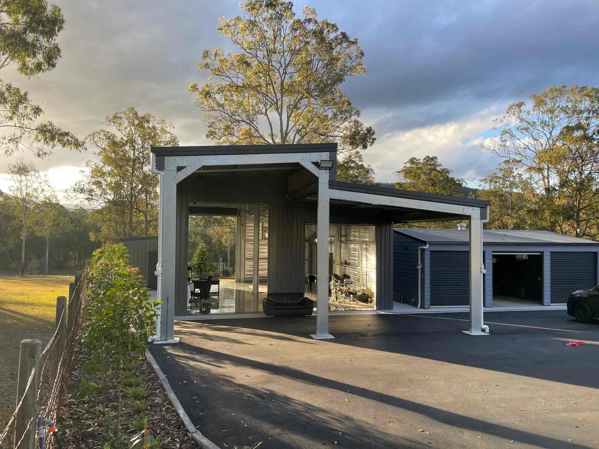 A house with a garage and a pergola in front of it. — Just Sheds In Brisbane, QLD