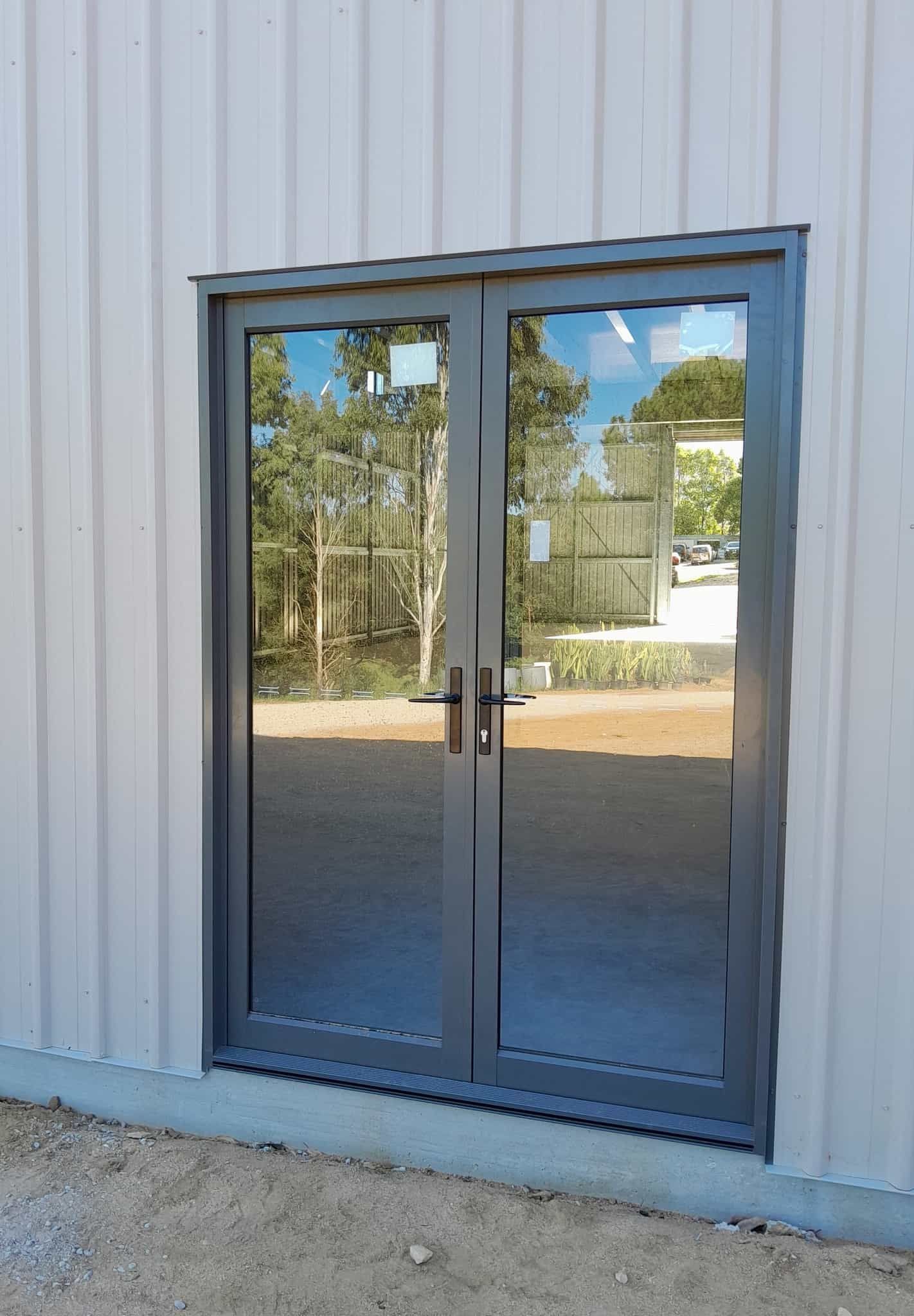 A door with a lot of glass is on the side of a building. — Just Sheds In Kunda Park, QLD