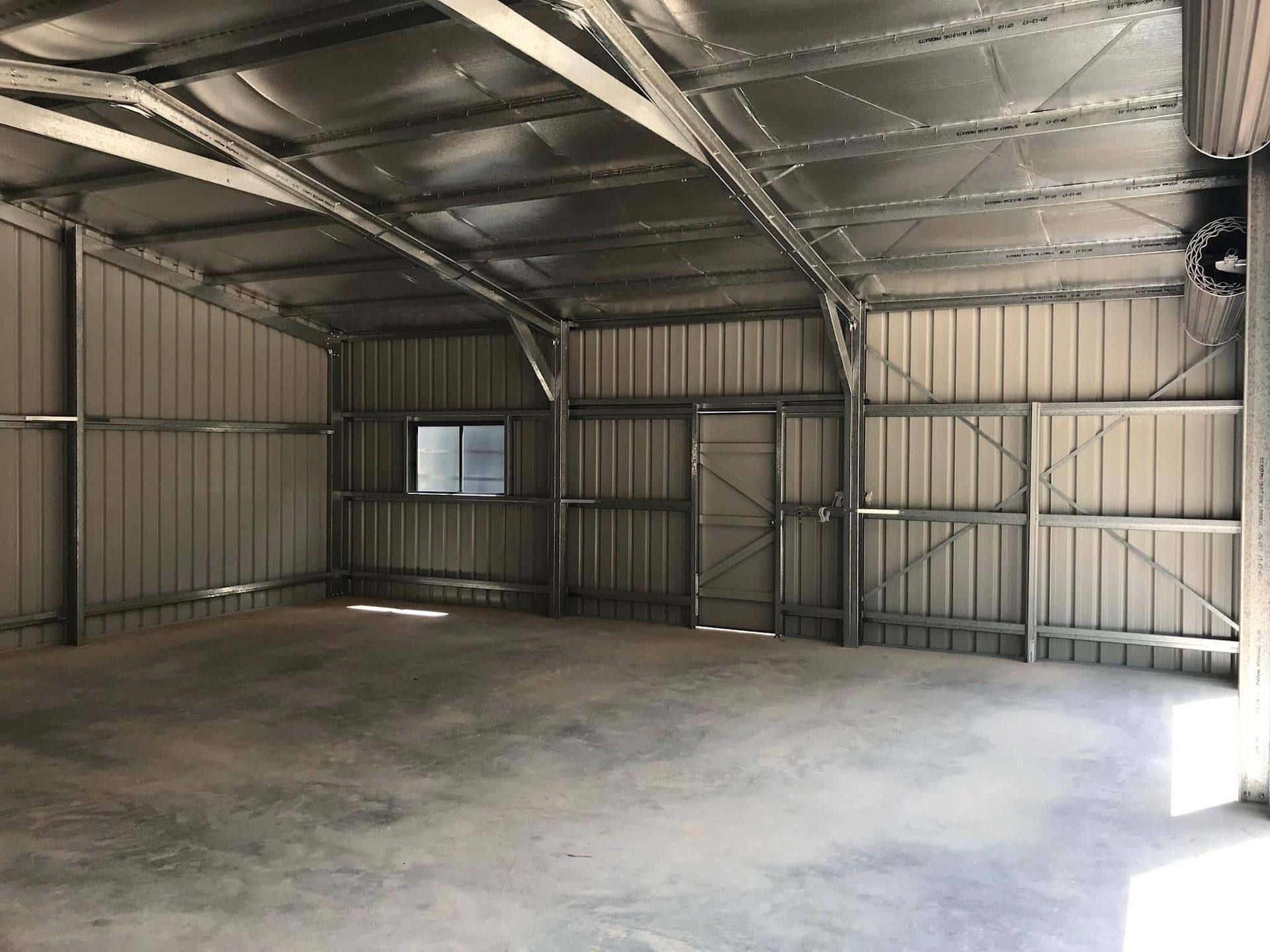 A large empty warehouse with a window and a door. — Just Sheds In Kunda Park, QLD