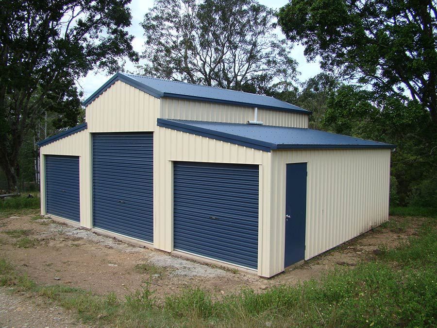 A White Garage With Blue Doors and a Blue Roof — Just Sheds In Kunda Park, QLD